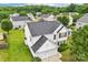 Two-story house with a new roof and attached two-car garage sits on a large lot with lush lawn and mature trees at 3038 Old Ironside Dr, Charlotte, NC 28213