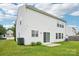 White home featuring a sliding glass door leading to a patio and grassy backyard at 3038 Old Ironside Dr, Charlotte, NC 28213
