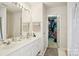 Bathroom features double sinks, a walk-in closet, and a walk-in shower at 3038 Old Ironside Dr, Charlotte, NC 28213
