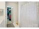 Bright bathroom showcasing a shower with a stylish curtain and a walk-in closet at 3038 Old Ironside Dr, Charlotte, NC 28213