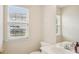 Powder room featuring a white vanity, mirror, and window at 3038 Old Ironside Dr, Charlotte, NC 28213