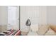 Inviting bedroom features a comfortable sofa with direct access to additional rooms and closet at 3038 Old Ironside Dr, Charlotte, NC 28213