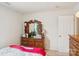 Bedroom featuring a dresser with a mirror, lamp and books, offers a cozy and functional space at 3038 Old Ironside Dr, Charlotte, NC 28213