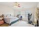 Bright bedroom with a bed, treadmill, and desk in front of a window at 3038 Old Ironside Dr, Charlotte, NC 28213