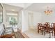 Bright dining room leads to outdoor seating, highlighted by a beautiful chandelier and wooden furniture at 3038 Old Ironside Dr, Charlotte, NC 28213