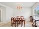 Bright dining room with ample space, natural light, and elegant chandelier above wooden table at 3038 Old Ironside Dr, Charlotte, NC 28213