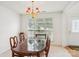 Sunlit dining room with a large window and charming chandelier, perfect for Gathering meals at 3038 Old Ironside Dr, Charlotte, NC 28213