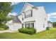 Charming two-story home featuring a white exterior, well-maintained lawn, and attached garage at 3038 Old Ironside Dr, Charlotte, NC 28213