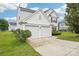Charming two-story home boasts a two-car garage and well-maintained landscaping at 3038 Old Ironside Dr, Charlotte, NC 28213