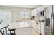 Open kitchen with an island, white cabinets, and modern appliances at 3038 Old Ironside Dr, Charlotte, NC 28213
