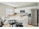 Bright kitchen with white cabinets and stainless steel appliances at 3038 Old Ironside Dr, Charlotte, NC 28213
