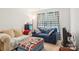 Bright living room with a sofa, window, and side table, perfect for relaxing and entertaining at 3038 Old Ironside Dr, Charlotte, NC 28213