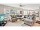Bright living room features a large sectional sofa, multiple windows and open floor plan at 3038 Old Ironside Dr, Charlotte, NC 28213