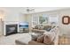 The living room features a cozy fireplace, TV, and ample seating, creating a warm and inviting atmosphere at 3038 Old Ironside Dr, Charlotte, NC 28213