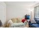 Cozy living room featuring a comfortable sofa, mini fridge, and plenty of natural light at 3038 Old Ironside Dr, Charlotte, NC 28213
