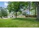 Large backyard featuring mature trees and ample green space at 3050 Millstone Dr, Gastonia, NC 28054