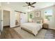 Bedroom featuring ensuite bathroom with sliding barn door, ceiling fan and ample natural light at 3050 Millstone Dr, Gastonia, NC 28054