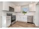 Modern kitchen featuring white cabinets, stainless steel appliances, and stylish subway tile backsplash at 3050 Millstone Dr, Gastonia, NC 28054