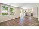 Open-concept living room leading into a modern kitchen with stainless steel appliances and white cabinetry at 3050 Millstone Dr, Gastonia, NC 28054