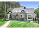 Stunning outdoor screened porch area with fireplace, TV and dining space for relaxation and entertainment at 317 Marietta Rd, Mooresville, NC 28117