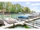 Dock with several covered pontoon boats floating on the lake at 317 Marietta Rd, Mooresville, NC 28117