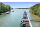 Lake view of boat dock featuring several boats, calm water, and a treelined shoreline at 317 Marietta Rd, Mooresville, NC 28117