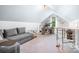 Spacious bonus room with sloped ceilings that features an office, lounge area and carpet floors at 317 Marietta Rd, Mooresville, NC 28117