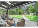 Inviting covered patio with comfortable seating, a ceiling fan, and a view of the lush backyard at 317 Marietta Rd, Mooresville, NC 28117