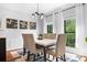 Stylish dining room featuring modern chandelier, wainscoting, and large windows for natural light at 317 Marietta Rd, Mooresville, NC 28117