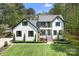 Beautiful two-story white brick home featuring black shutters and a well-manicured lawn at 317 Marietta Rd, Mooresville, NC 28117