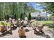 Charming backyard fire pit with unique cauldron and stump seating amid mature trees and landscape at 317 Marietta Rd, Mooresville, NC 28117