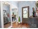 Elegant foyer with hardwood floors, decorative mirror, and a view into the dining room at 317 Marietta Rd, Mooresville, NC 28117