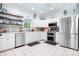 Clean bright kitchen with stainless steel appliances, white cabinets, gray backsplash, and tiled floor at 317 Marietta Rd, Mooresville, NC 28117