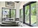 Cozy sunroom with large windows, sleek black chairs, and a charming fireplace at 317 Marietta Rd, Mooresville, NC 28117
