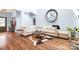 Inviting living room with hardwood floors, large sectional sofa, and decorative round mirror at 317 Marietta Rd, Mooresville, NC 28117