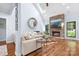 Bright living room features a stone fireplace, hardwood floors, and large windows bringing natural light at 317 Marietta Rd, Mooresville, NC 28117
