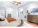 Main bedroom with a large bed, wood dresser, private balcony, and tray ceiling at 317 Marietta Rd, Mooresville, NC 28117
