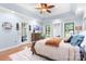Light-filled main bedroom with a large bed, wood dresser, and access to a private balcony at 317 Marietta Rd, Mooresville, NC 28117