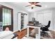 Bright home office featuring a ceiling fan, a large desk, and wood flooring at 317 Marietta Rd, Mooresville, NC 28117