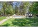 An inviting pool area with a custom gazebo and manicured landscaping make this backyard an oasis at 317 Marietta Rd, Mooresville, NC 28117
