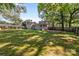 Spacious backyard with a wooden fence, patio, and a covered porch perfect for relaxing and entertaining at 319 N Central Ave, Locust, NC 28097