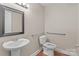 Bathroom featuring a pedestal sink, toilet, and grab bars for accessibility at 319 N Central Ave, Locust, NC 28097
