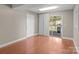 Bright bonus room featuring wood floors, sliding glass door, and access to the back deck at 319 N Central Ave, Locust, NC 28097