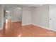 Bright bonus room showcasing wood floors and neutral paint at 319 N Central Ave, Locust, NC 28097