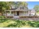 Charming home featuring a cozy front porch, stone accents, fresh landscaping and beautiful curb appeal at 319 N Central Ave, Locust, NC 28097