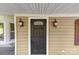 A charming front door with decorative sidelights and elegant hardware creates a welcoming entrance at 319 N Central Ave, Locust, NC 28097