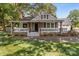 Beautiful home featuring a covered porch with stone accents and lush landscaping at 319 N Central Ave, Locust, NC 28097