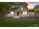 Charming home with a welcoming front porch and well-maintained landscaping at 319 N Central Ave, Locust, NC 28097