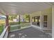 Relaxing front porch offers a serene spot to unwind while overlooking the landscaped yard at 319 N Central Ave, Locust, NC 28097