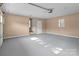 A well-lit garage features gray epoxy floors, access to home and plenty of storage space at 319 N Central Ave, Locust, NC 28097